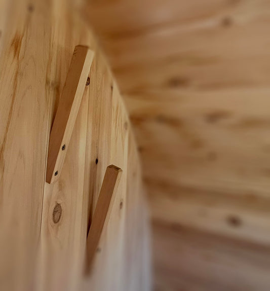 Handcrafted cedar hooks that we install on the interior left wall of your sauna.